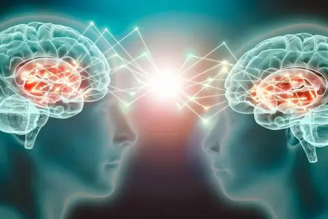 Dwa mózgi połączone siecią neuronów, symbolizujące komunikację i wyrzut dopaminy.